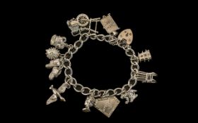 Sterling Silver Bracelet Loaded with Eleven (11) Sterling Silver Charms of various subjects.