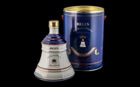 Bell's Old Scotch Whiskey in Commemorative Tin containing Bell's whiskey decanter in porcelain