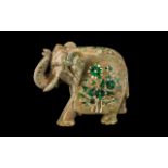 Inlaid Indian Soapstone Elephant with its trunk up, decorated to its back with a floral pattern,
