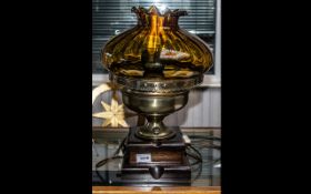 Large Converted Oil Lamp raised on wooden base, with large amber glass fluted edge shade, with flex.