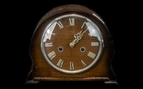 Small 1950s Oak Cased Mantle Clock with chrome numerals to the face and outer glass rim.