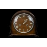 Small 1950s Oak Cased Mantle Clock with chrome numerals to the face and outer glass rim.