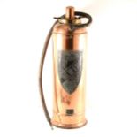 A vintage copper 'New Era' fire extinguisher
