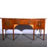 A George III style mahogany serpentine sideboard,