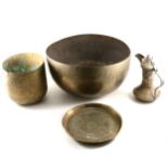 An Indian engraved brass circular basin, and other Eastern metal ware