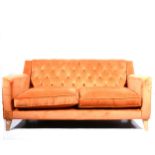 A button rust velvet two-seater settee, beechwood supports