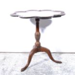 A reproduction mahogany pedestal table, lobed tilt-top