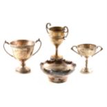 Three silver trophy cups plus a silver bowl.