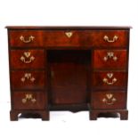 A George III style mahogany kneehole desk, adapted