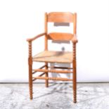 An Arts & Crafts inspired beechwood elbow chair