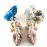 A pair of Continental porcelain wall pockets, modelled with cherubs; a modelled cat posy bowl...