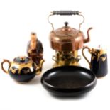 A copper kettle with brass burner, Doulton black dish, teapot, milk jug and monk decanter.