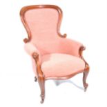 A Victorian easychair, shaped back
