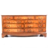 A reproduction mahogany finish chest of drawers,