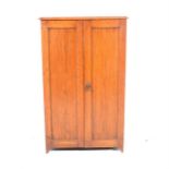 An oak shoe cupboard, two panelled doors, width 57cm.