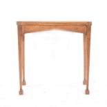 An Edwardian oak card table,