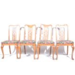 A set of four Edwardian mixed wood dining chairs