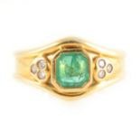 An emerald and diamond dress ring.