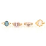 Four gemset dress rings, to include aquamarine, blue topaz, kunzite and morganite.