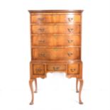 A reproduction mahogany finish serpentine chest on stand,