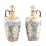 A pair of Doulton stoneware flasks with silver rim and stoppers with corks.