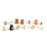 A large collection of ceramic thimbles,