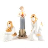Three Spanish ceramic figures and publications relating to Lladro.