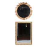 A circular bevel-edge wall mirror; and a rectangular bevelled mirror