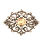 A late Victorian diamond brooch with golden yellow stone to centre.