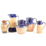 Five assorted Doulton Lambeth stoneware jugs