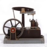 A Stuart Turner beam engine; live steam model with 7inch flywheel, mounted into wooden base, 32cm