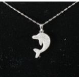 A diamond set dolphin pendant.