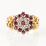A vintage ruby and diamond circular cluster ring.