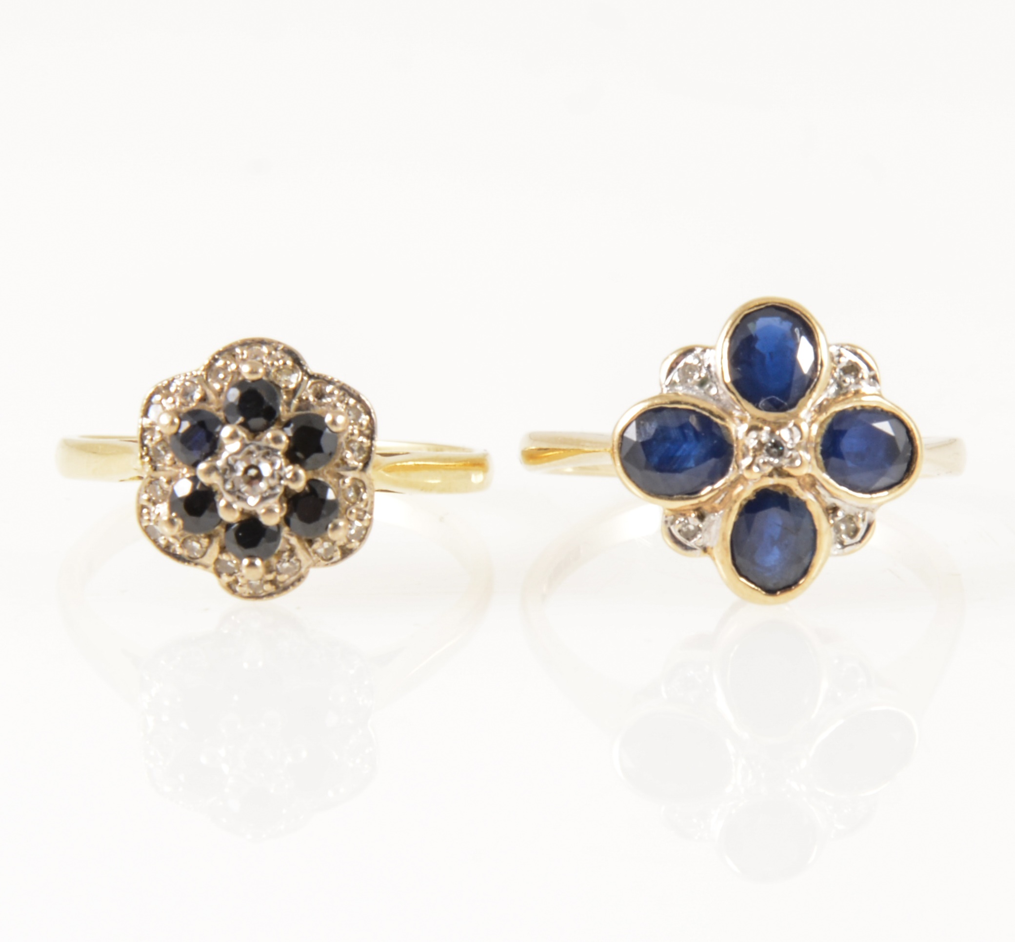Two sapphire and diamond circular cluster rings.