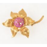 An 18 carat yellow gold and ruby floral brooch.