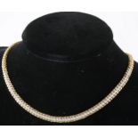 A 9 carat yellow and white gold collar necklace set with small diamonds.
