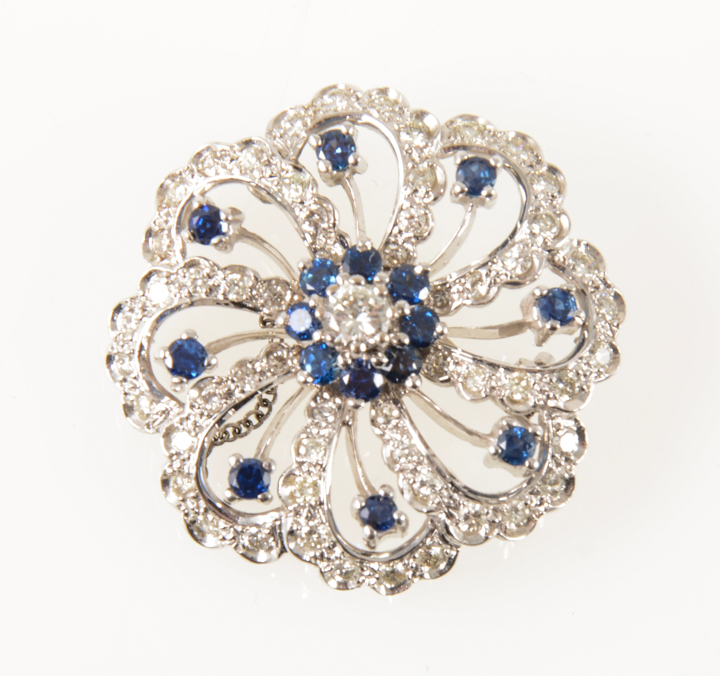 A sapphire and diamond brooch.