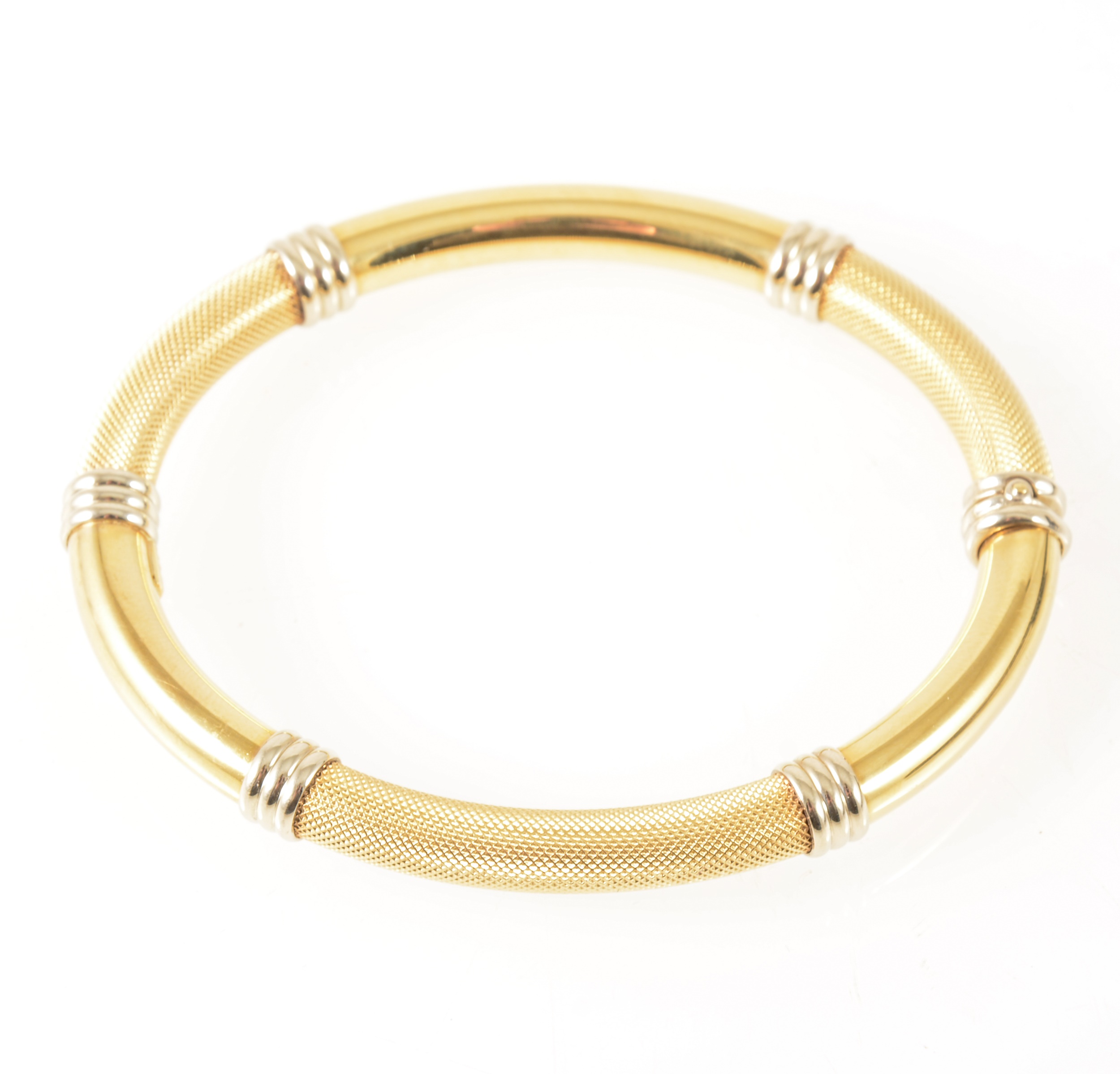 WITHDRAWN - A modern yellow and white metal half hinged bangle marked 750.