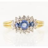 A sapphire and diamond boat shape cluster ring.