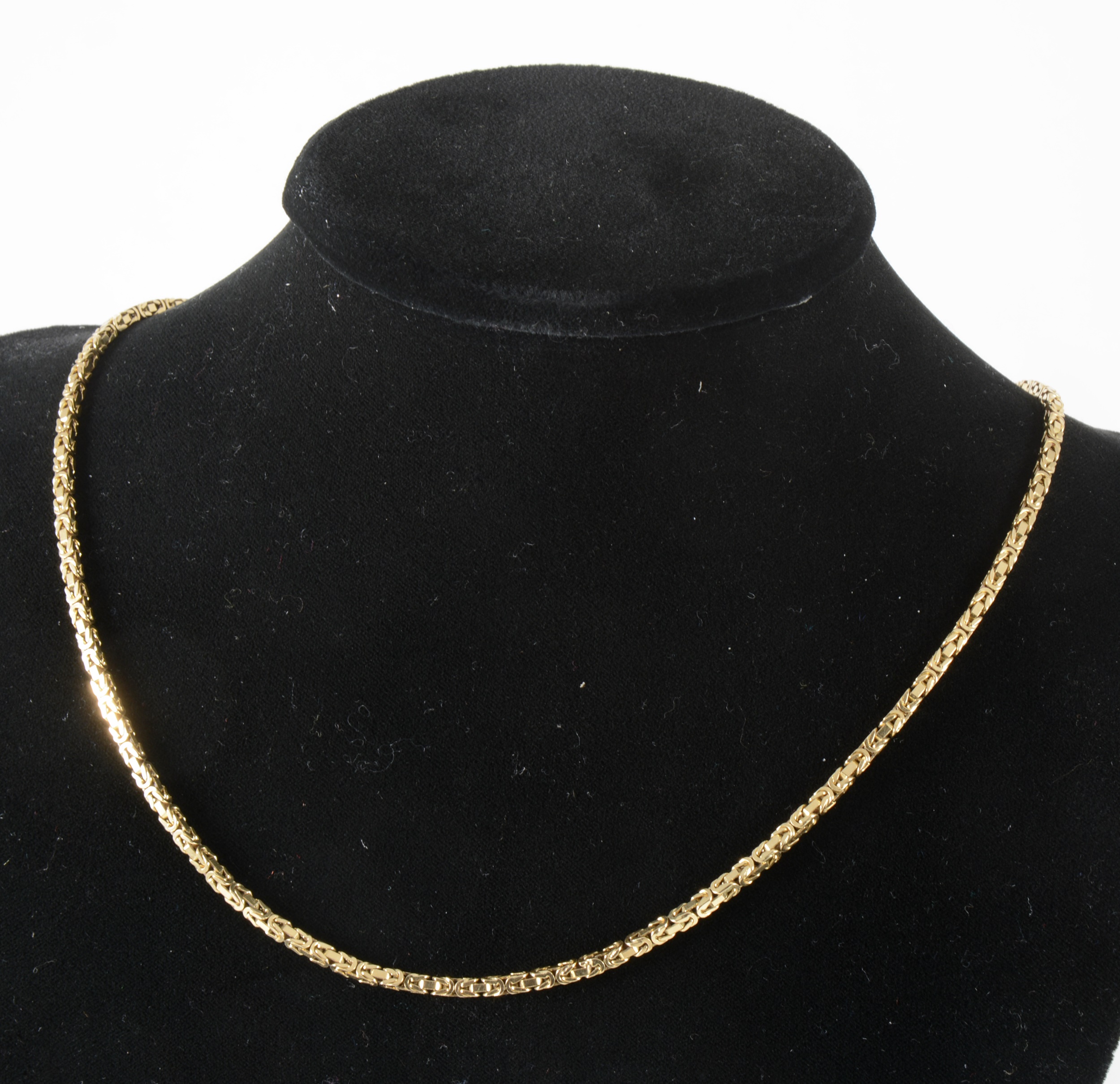 An 18 carat yellow gold square kings pattern chain necklace.