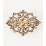 A late Victorian diamond brooch with golden yellow stone to centre,