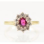 A ruby and diamond oval cluster ring.