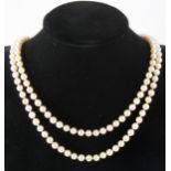 A two row cultured pearl necklace with garnet clasp.