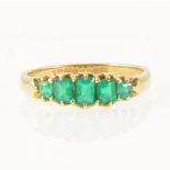 An emerald five stone half hop ring.