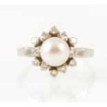 A pearl and diamond circular cluster dress ring.