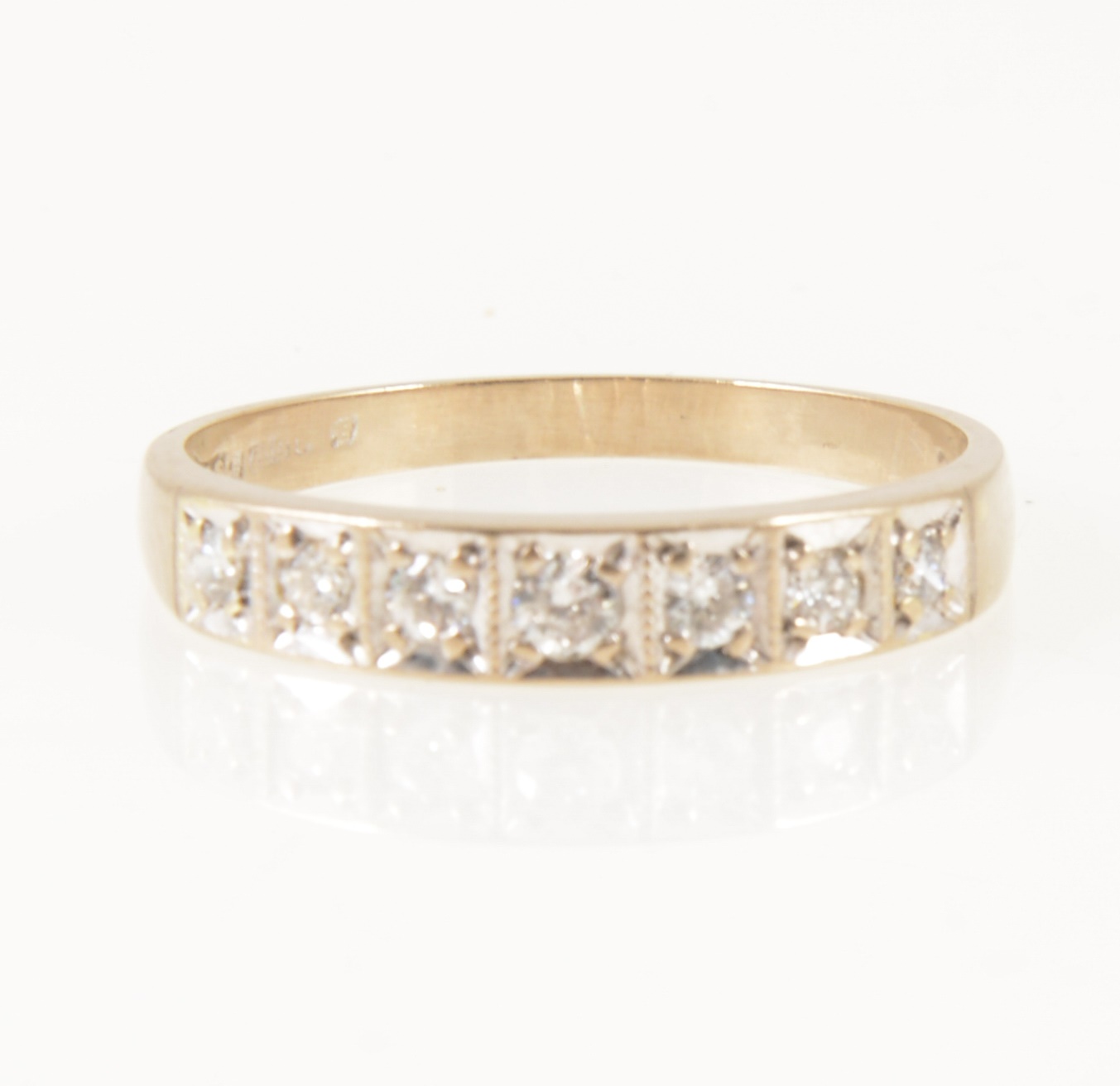 A diamond half eternity ring.