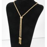 A 9 carat yellow and white gold necklace with tassel ends.