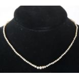 A pearl necklace with diamond set clasp.