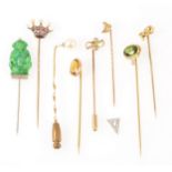 Eight gemset tie pins and another triangular tie pin top