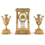 A French gilt metal and champleve enamel clock garniture